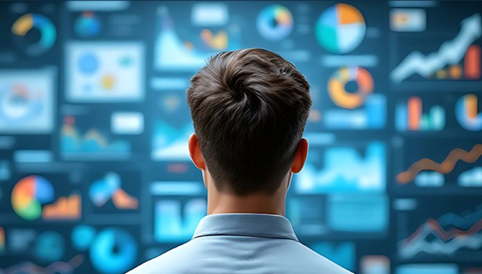 Un professionista osserva da vicino un grande schermo digitale con grafici e dashboard interattivi, rappresentazione visiva dei processi di analisi e gestione documentale in cloud per migliorare produttività, sicurezza dei dati e collaborazione aziendale