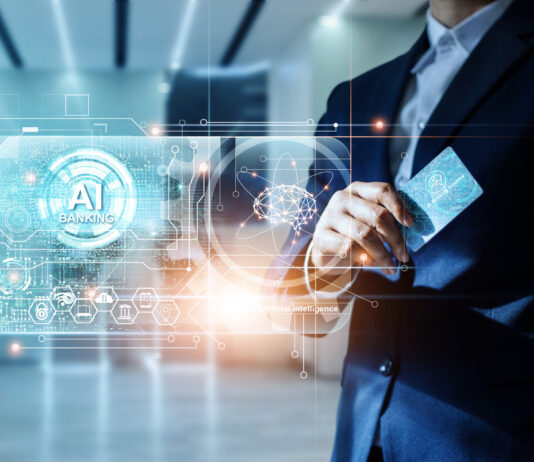 Uomo d'affari in un ambiente futuristico utilizza un'interfaccia olografica di AI Banking con una carta, simboleggiando l'innovazione nei servizi finanziari e la riconciliazione bancaria automatizzata
