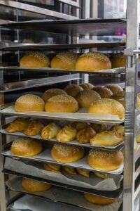fresh hot buns in handcart from oven