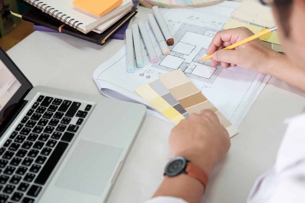 Graphic design and color swatches and pens on a desk. Architectu