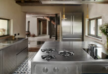 Ergonomia e design nel progetto Abimis a Belluno I blocchi operativi e il frigo in acciaio di Abimis arredano lo cucina della casa sulle Dolomiti