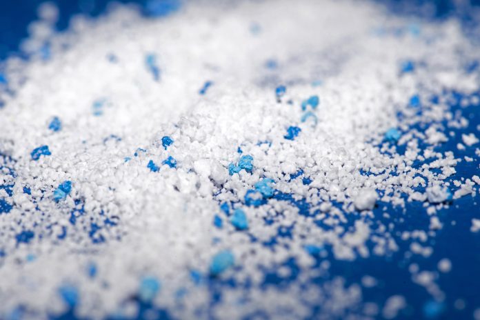 Small Plastic pellets on blue cloth.Micro plastic. Microplastiche nelle acque potabili