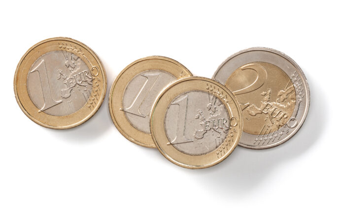 Euro coins isolated on white background closeup. Money concept. Modificato il tasso di interesse Inail
