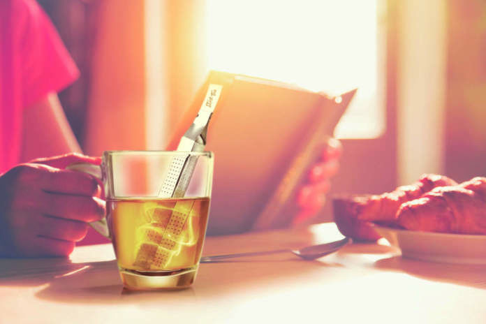 fresh breakfast with hot coffee and reading book in morning sunlight