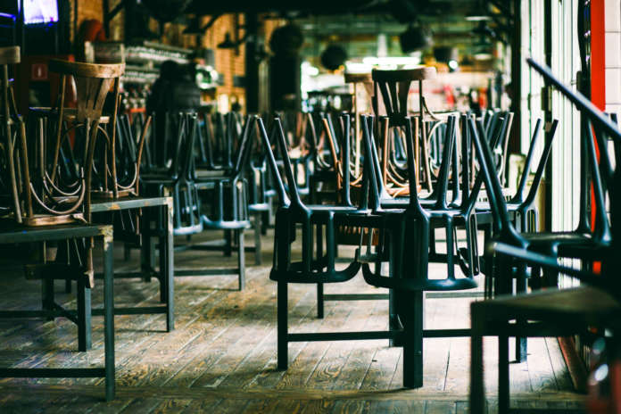 Chairs and tables stacked in a closed pub