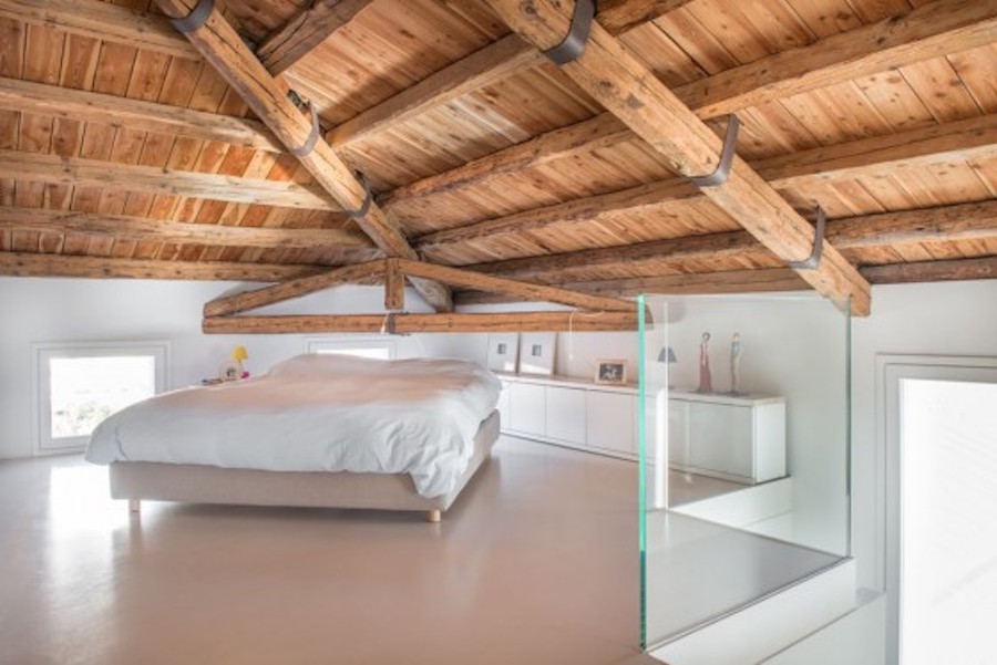 Una camera caratterizzata dall’intreccio di travi in legno (foto di Giovanni Schirè – Studio Corde)