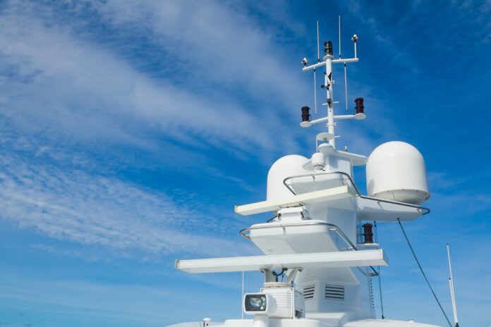 The mast of a large yacht with navigation equipment bottom view. Radar, signal lights, satellite dishes and equipment. elettronica marina