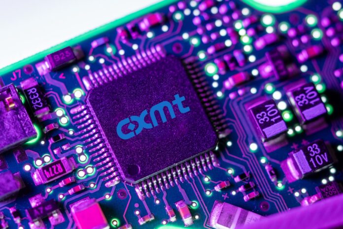 Macro shot of a CXMT semiconductor chip on a circuit board with neon lighting. CXMT