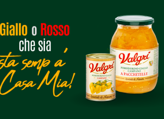 Pomodorino Giallo Campano Valgri, sole dorato della Campania Conserve Valgrì di Pomodorino Giallo Campano intero e a pacchetelle, accompagnate dallo slogan 'Giallo o Rosso che sia, sta semp' a Casa Mia!' su sfondo verde scuro.
