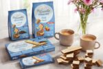 • Confezioni di wafer Lago Group Be-Goodie Sugar Free in vari formati esposte a Tutto-food 2026 con tazze di caffè su un tavolo