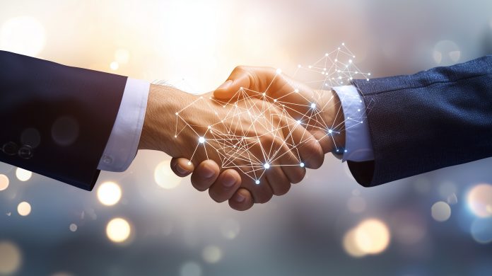 Two businessmen shake hands, a digital network connecting them, symbolizing a strategic partnership, collaboration, and business growth