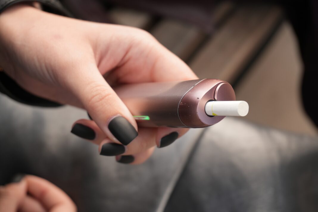 Close-up,Of,A,Hand,Holding,An,Electronic,Cigarette,Device,With Fumo