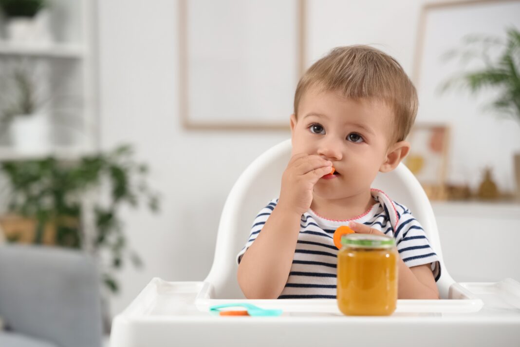 Cute,Little,Baby,With,Jar,Of,Tasty,Food,And,Carrot PMSP