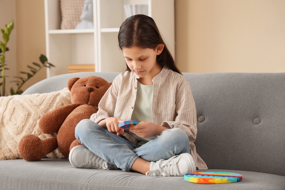 Cute,Girl,With,Autistic,Disorder,And,Pop,It,Fidget,Toy