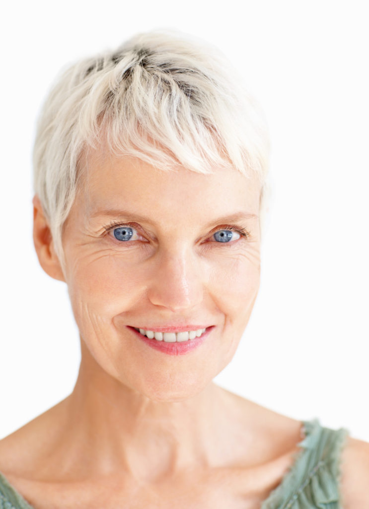 Closeup of an old senior grandmother smiling confidently