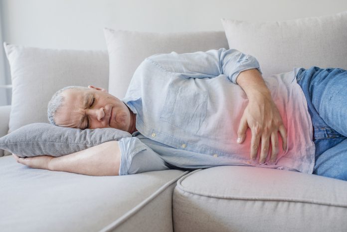 Man suffering from stomach ache because he has diarrhea