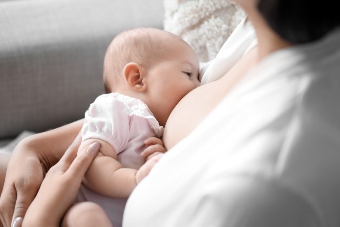 Young,Woman,Breastfeeding,Her,Baby,At,Home,,Closeup
