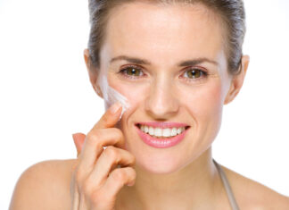 Trans-resveratrolo: doppia azione contro l’invecchiamento cutaneo Una donna applica della crema sul viso