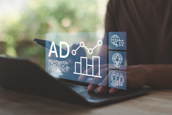 Digital advertising analytics dashboard on laptop with ad performance metrics, marketing data charts, audience targeting icons. Online campaign optimization and data driven marketing strategy concept.