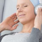 Woman with cancer listening to music