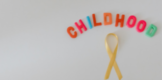 Giornata Mondiale contro i tumori pediatrici: il ruolo degli interventi integrativi nel supporto oncologico Nastro giallo simbolo dei tumori pediatrici con scritta “Childhood Cancer”