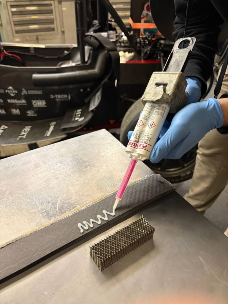 Application of Plexus MA 300 adhesive to the carbon test specimen for testing the bond between carbon and honeycomb