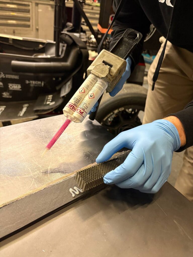 Application of Plexus MA 300 adhesive to the carbon test specimen for testing the bond between carbon and honeycomb