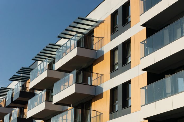 Modern,Apartment,Building,Against,A,Clear,Blue,Sky.,Residential,Building