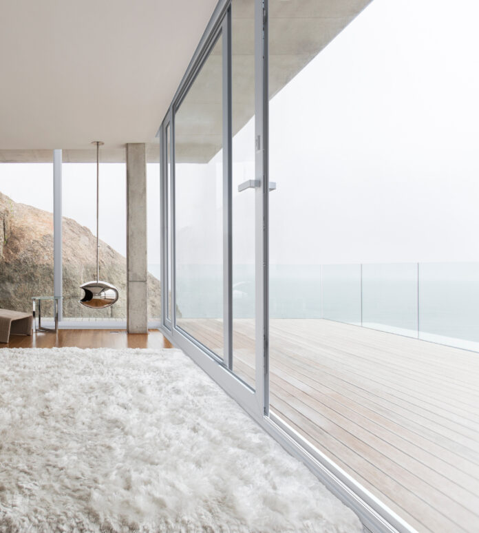 Shag rug and glass walls in modern bedroom