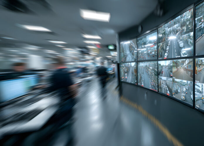 Security guards in security control room with video wall or legal service of danger in office Worker, law patrol, Police Officer's Expertise in an Emergency Call Center, Blurred image comuni videosorveglianza